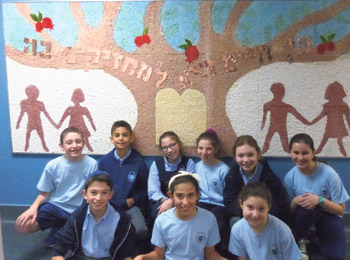 Seen are some of the Solomon Schechter Academy students who collaboratively created a large mosaic depicting the Tree of Life and the Ten Commandments that hangs in a prominent location at the school.