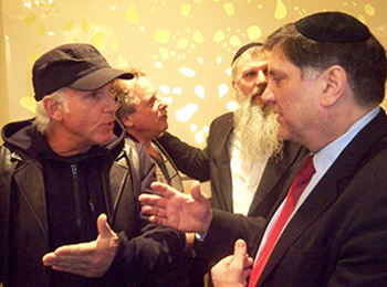 Jewish Defence League of Canada di-rector Meir Weinstein, right, speaks with audience members after Montreal meeting. JANICE ARNOLD PHOTO