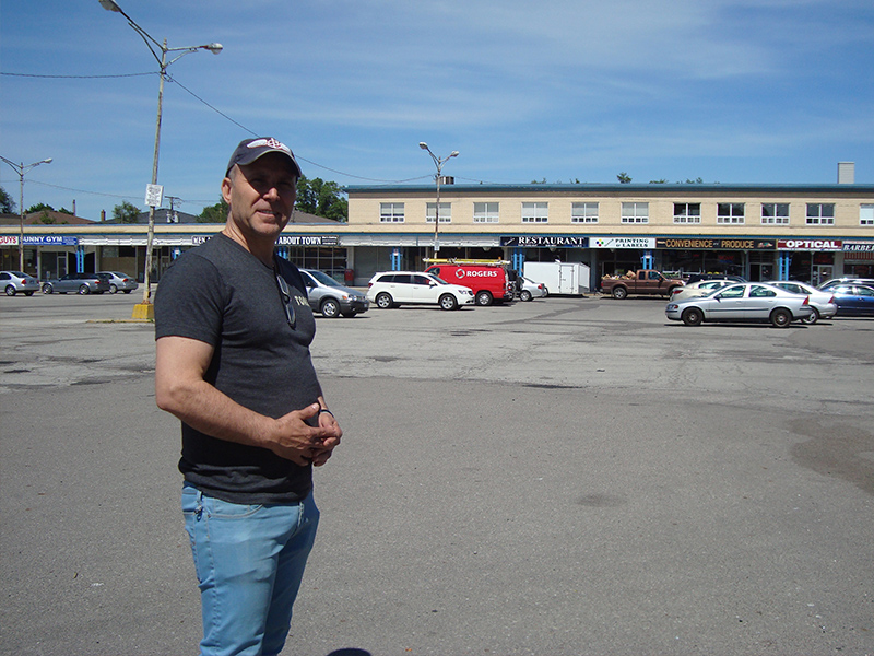 Uri Hazan of King David Pizza stands in the strip mall’s parking lot PAUL LUNGEN PHOTO