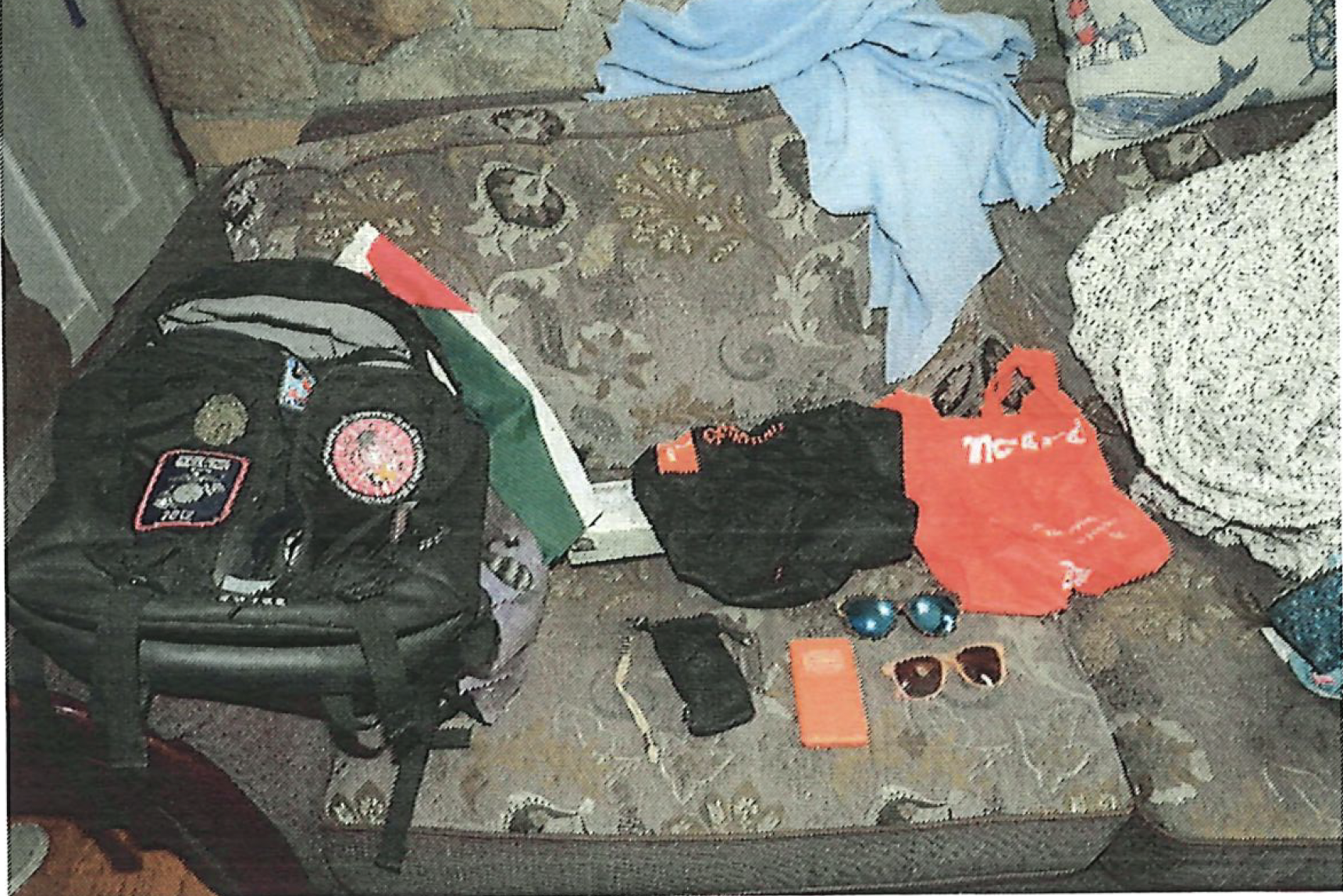 Black backpack with Palestinian flag and red paint.